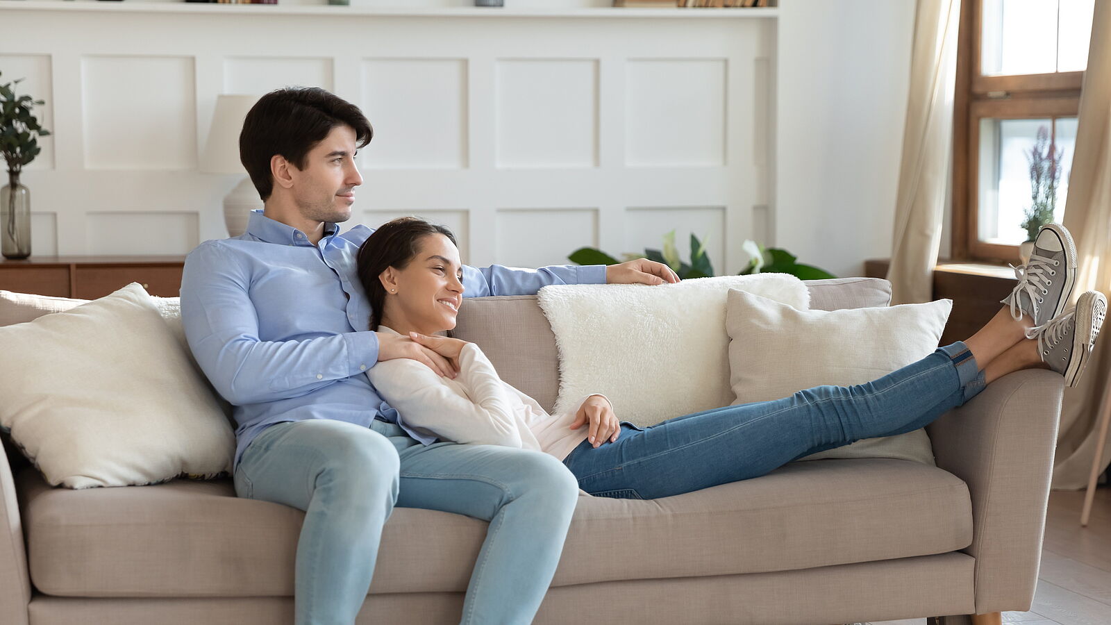 happy newlyweds on sofa